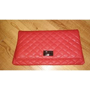 red quilted clutch bag .